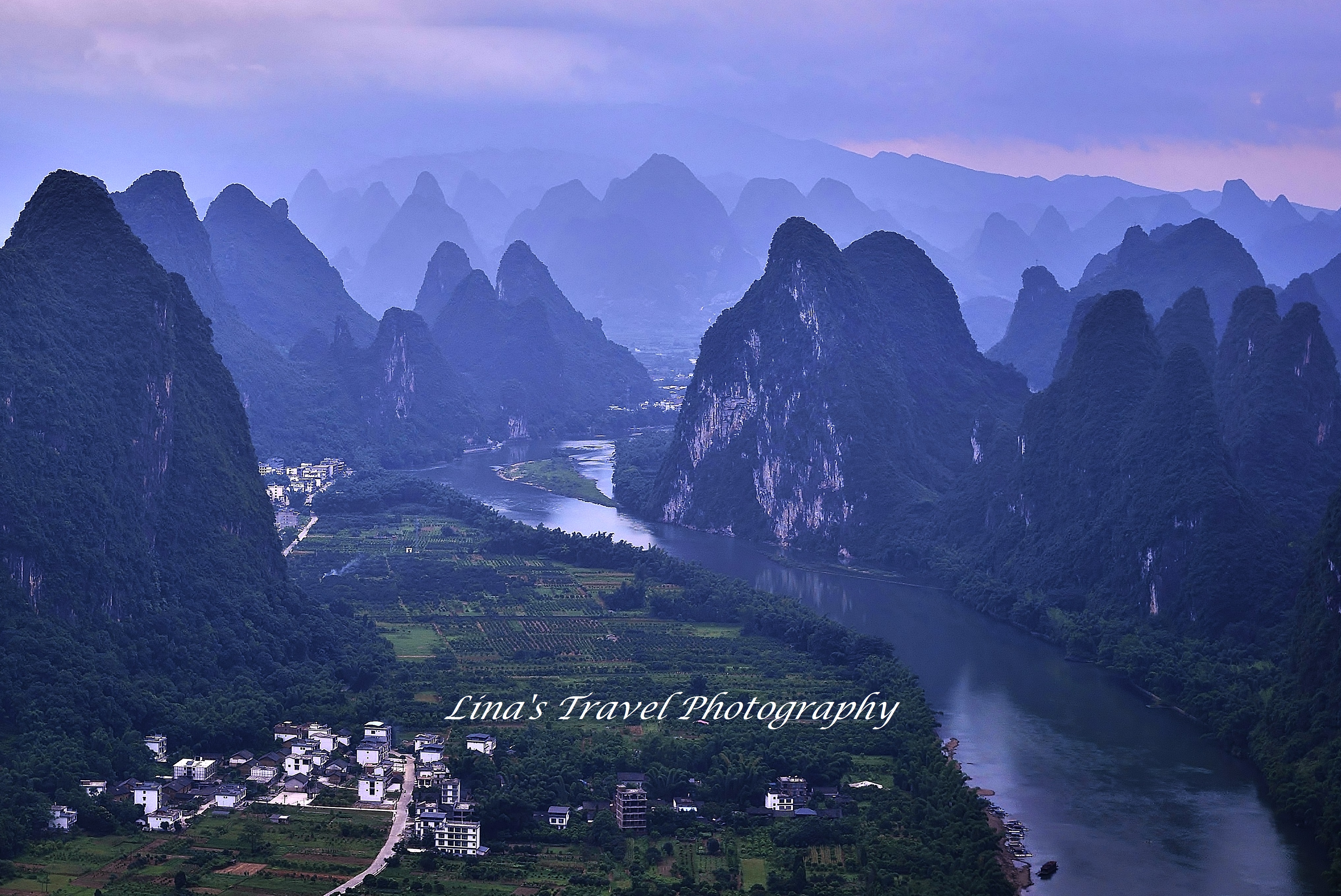 Sunrise over Xianggong Hill surrounded by karst landscape, Yangshuo, Guangxi, China
